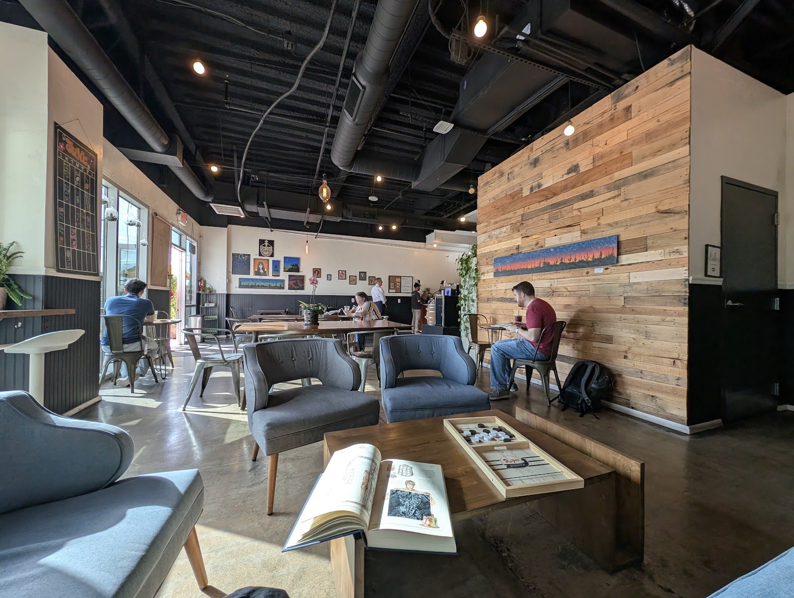 Lounge seating under an open industrial ceiling